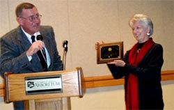Photo of Linda Blue holding a plaque.
