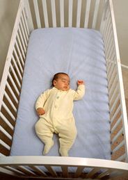 Photo of a baby in a crib.