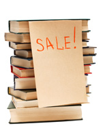 Photo of stack of books with SALE! on them.