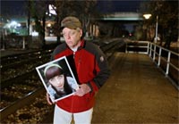 Walter Gaffney holds a picture of his 17-year-old daughter, Mary, along the tracks where she was killed in Hyattsville, Maryland. Photo: Post-Dispatch/David Carson