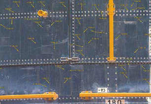This part was removed from the Hubble Space Telescope during in-space repairs. The yellow arrows show the damage from many orbital debris impacts.Photo courtesy of NASA.