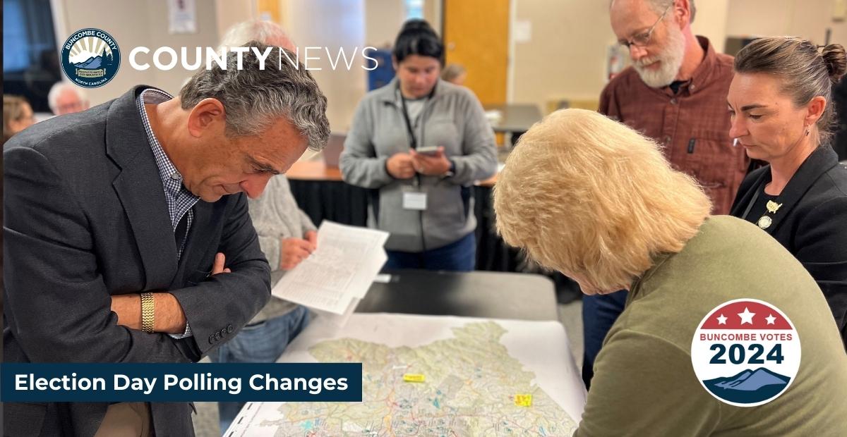 Board of Elections members look at a map